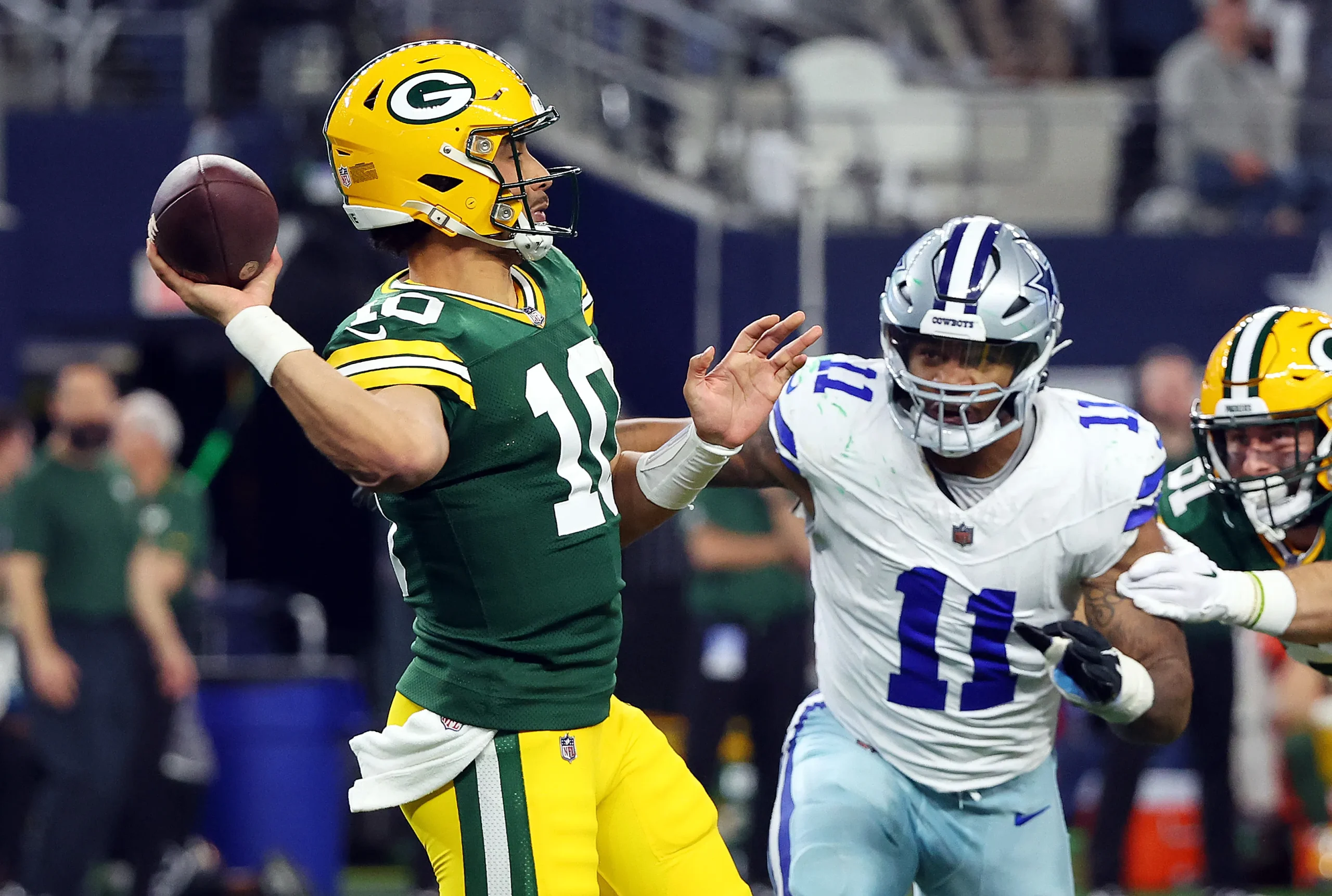 ARLINGTON, TEXAS - JANUARY 14: Quarterback Jordan Love #10 of the Green Bay Packers passes the ball under pressure from linebacker Micah Parsons #11 of the Dallas Cowboys at AT&T Stadium on January 14, 2024 in Arlington, Texas. (Photo by Richard Rodriguez/Getty Images) Getty Images

